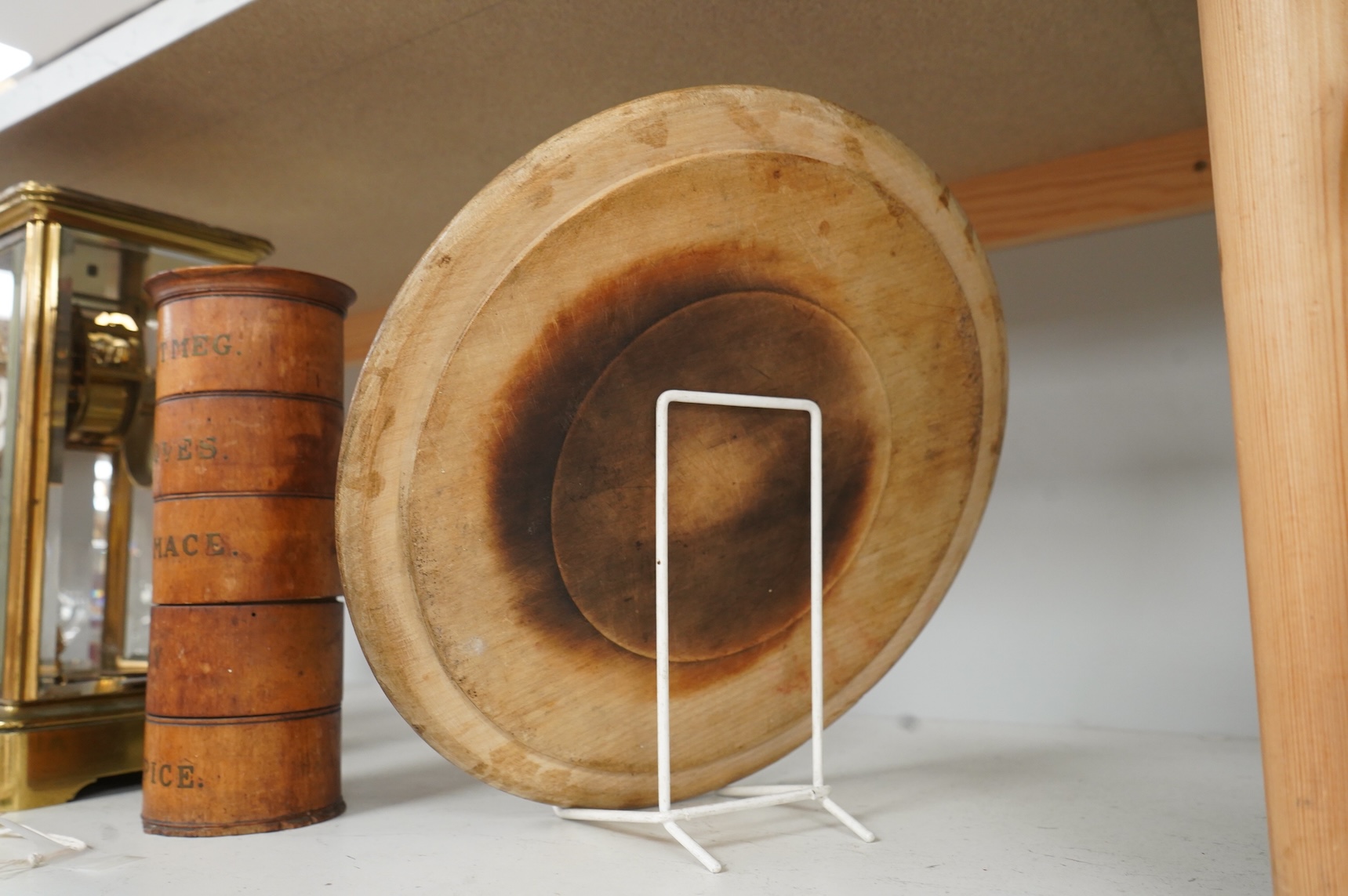 A Victorian treen spice tower and a carved bread board, 30cm in diameter